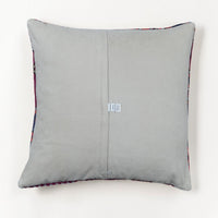 A square gray throw pillow with a central seam and a small white fabric tag, shown against a plain white background.