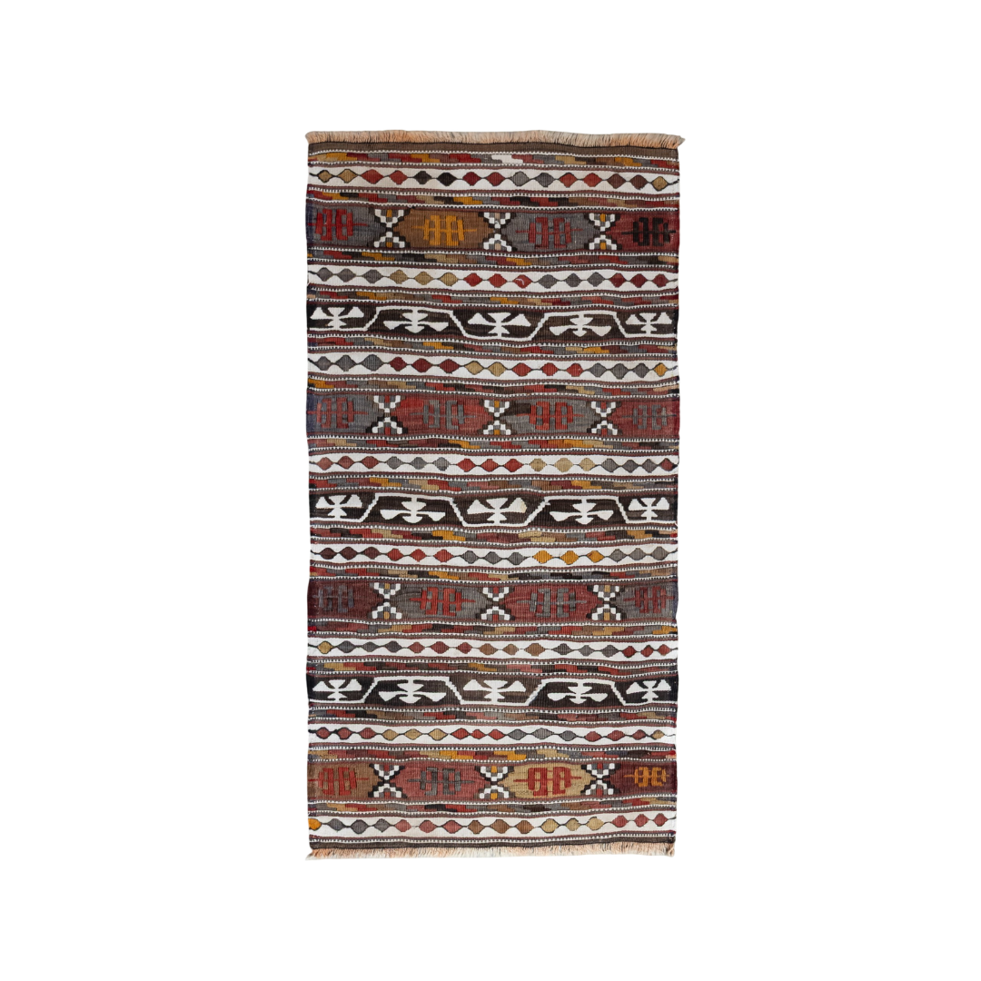 A rectangular kilim rug with horizontal bands of geometric patterns in red, black, white, and orange, shown flat against a white background.