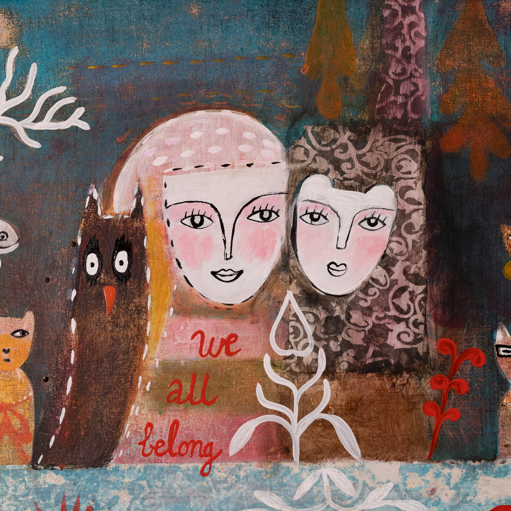 A stylized folk-art painting showing two human faces with pink cheeks and black outlines, one wearing a pale pink hat and the other in a dark patterned dress. A brown owl stands on the left, and the words 'we all belong' appear in red near the bottom center.