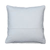 A square white throw pillow with a stitched hem, displayed flat on a rustic gray wooden plank background.