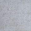 A close-up texture shot of a light beige or off-white loop-pile carpet or rug, showing the detailed woven fibers.