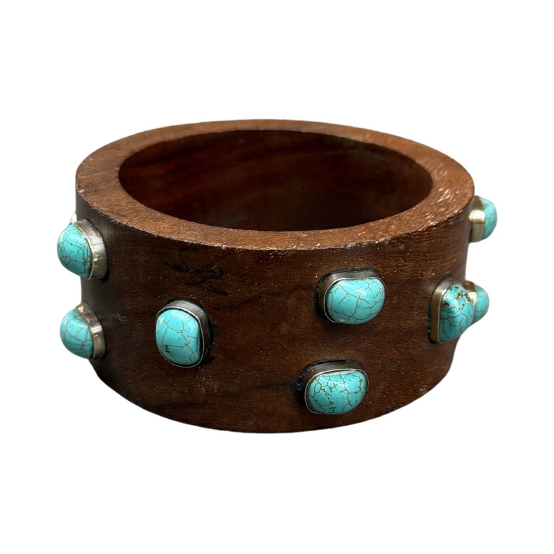 Wooden bracelet with turquoise stones on a white background