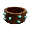 Wooden bracelet with turquoise stones on a white background