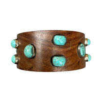 Wooden bracelet with turquoise stones on a white background