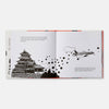 Open book with black and white illustrations of a castle and airplane on a white background