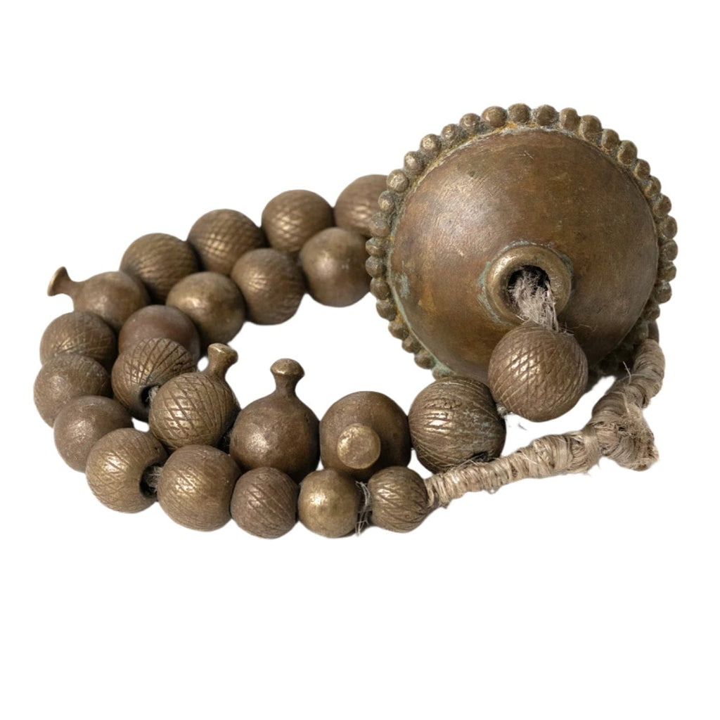 Bronze decorative object with spherical beads and a large central component on a white background