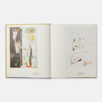Open book displaying artistic illustrations on a white background