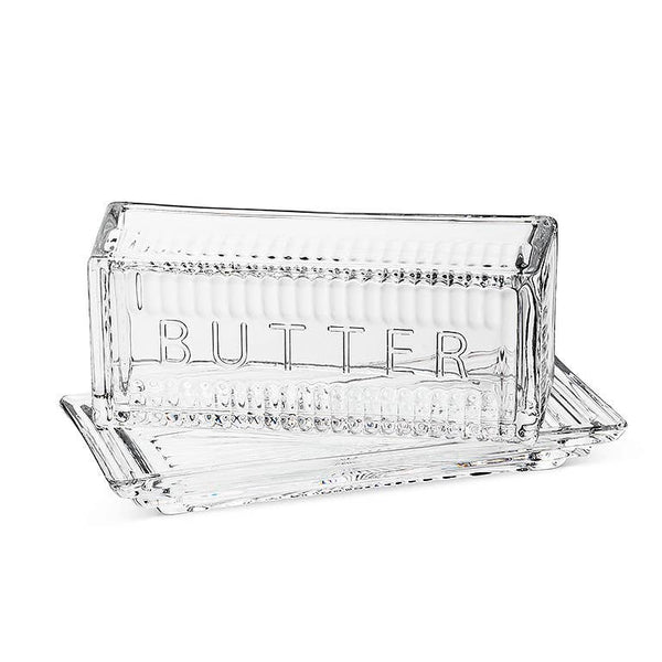 Clear glass butter dish with 'BUTTER' engraving on a white background