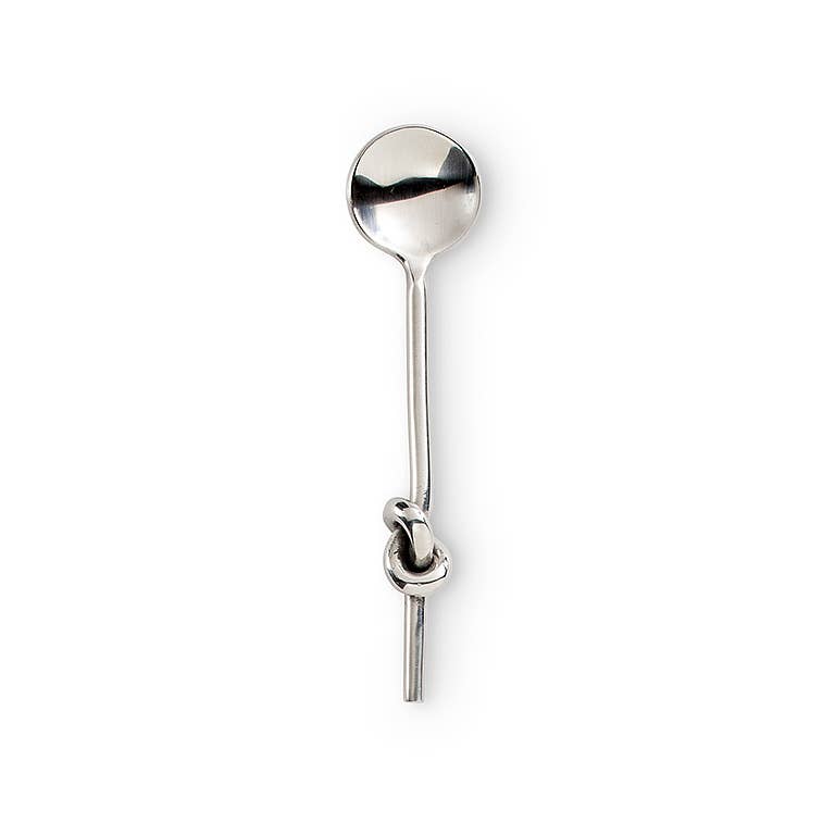 A polished silver-toned metal spoon with a decorative knot detail on its handle, shown against a plain white background.