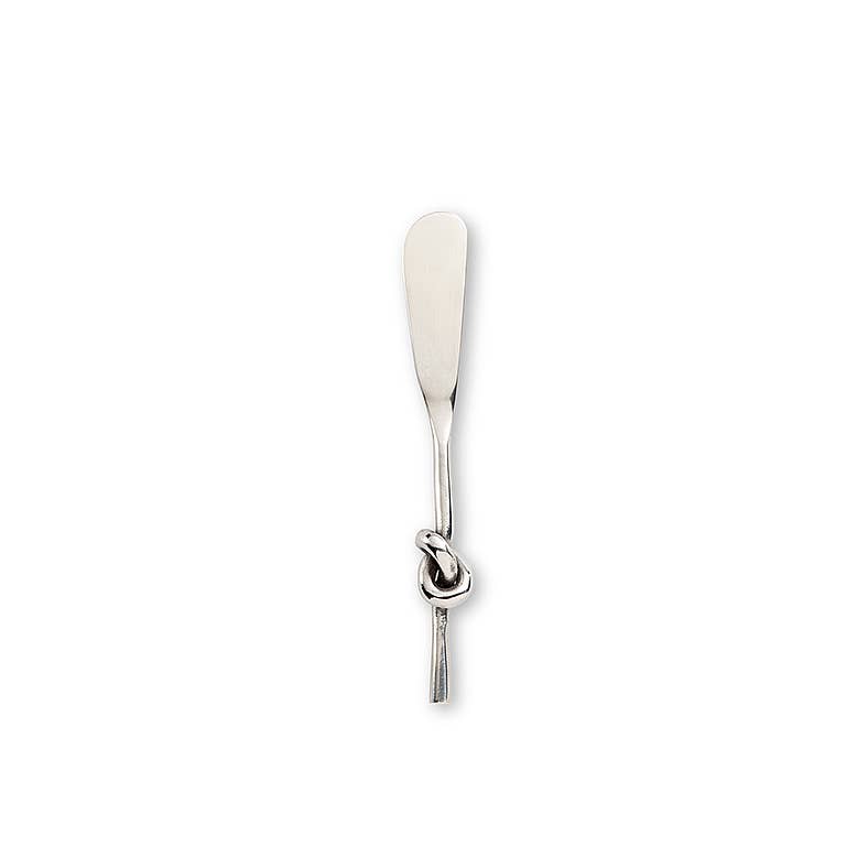 A polished silver-toned metal spatula with a decorative knot detail on the handle, shown against a plain white background.