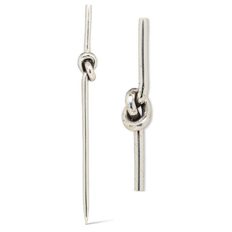 Silver knot cocktail pick on a white background