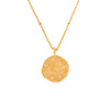 gold necklace with a round capricorn zodiac pendant