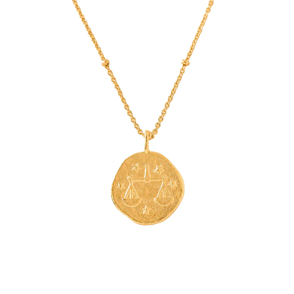 gold necklace with a round libra zodiac pendant