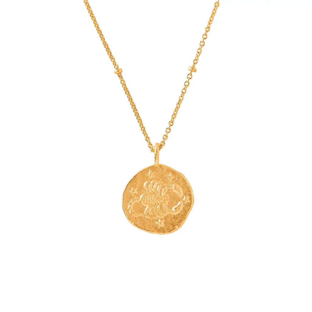 gold necklace with a round scorpio zodiac pendant
