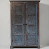 A rustic two-door cabinet with distressed blue-gray metal doors and weathered brown wood framing, shown against a plain light gray background.