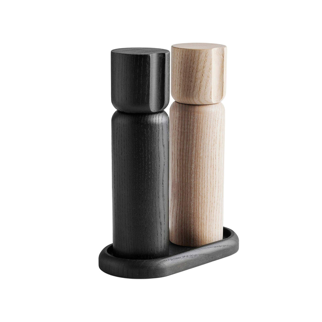 Black and wooden salt and pepper shakers on a white background