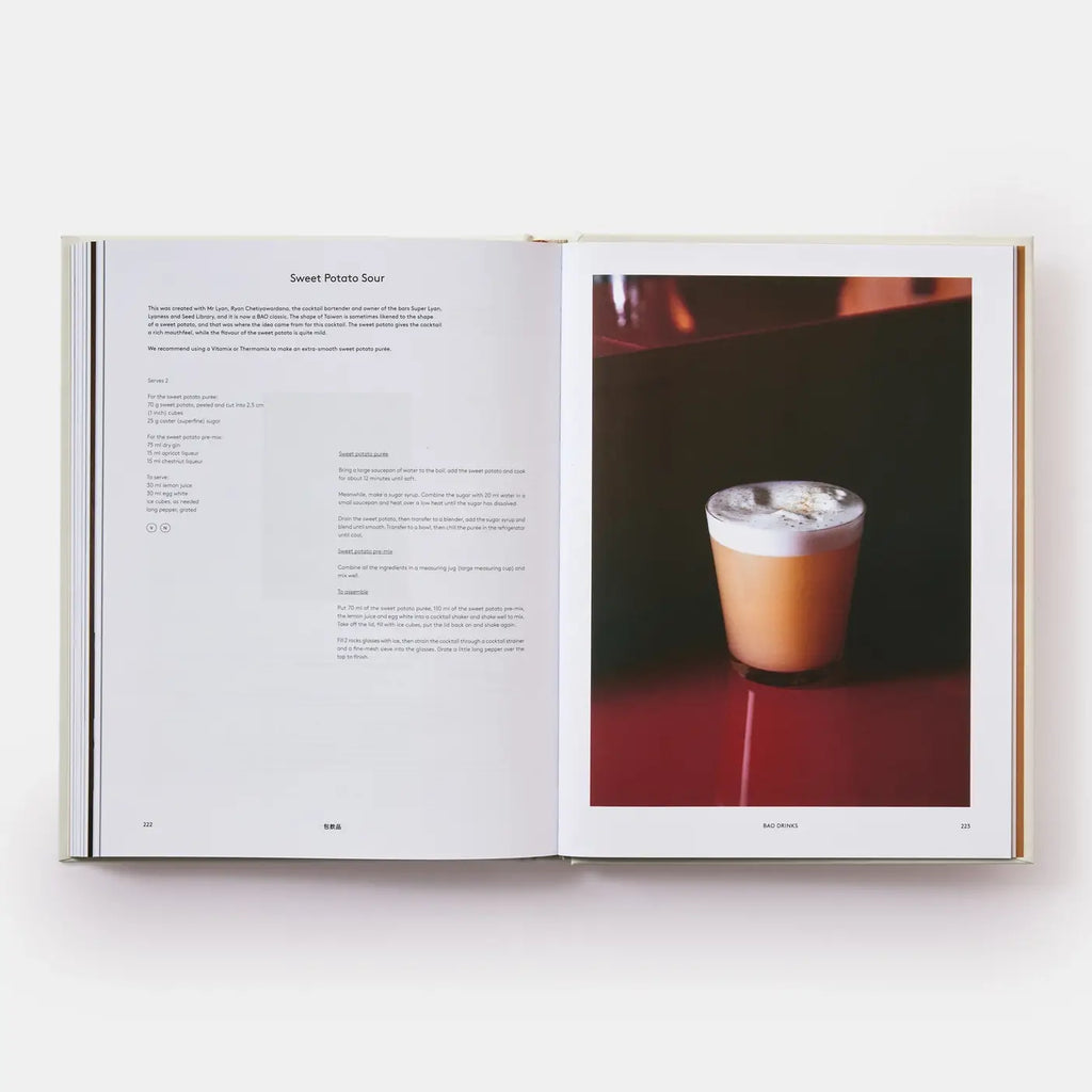Open book showing a page with text and an image of a drink on a red surface.