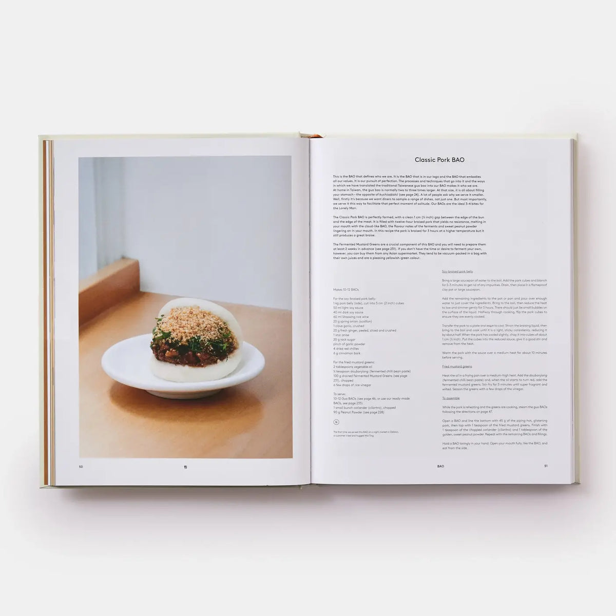 Open book showing a photograph of a dish on a wooden table with text on a white background