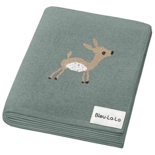 Folded green blanket with a deer illustration and 'Bleu-La-La' label on a white background