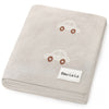 Folded beige blanket with cars and 'Bleu-La-La' label on a white background