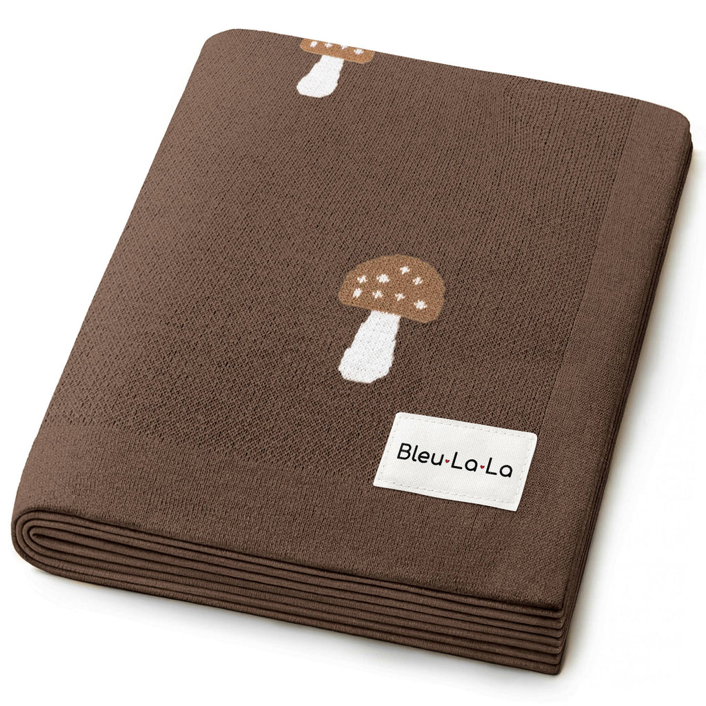 Brown fabric with mushroom design and Bleu-Lo-La label on a white background