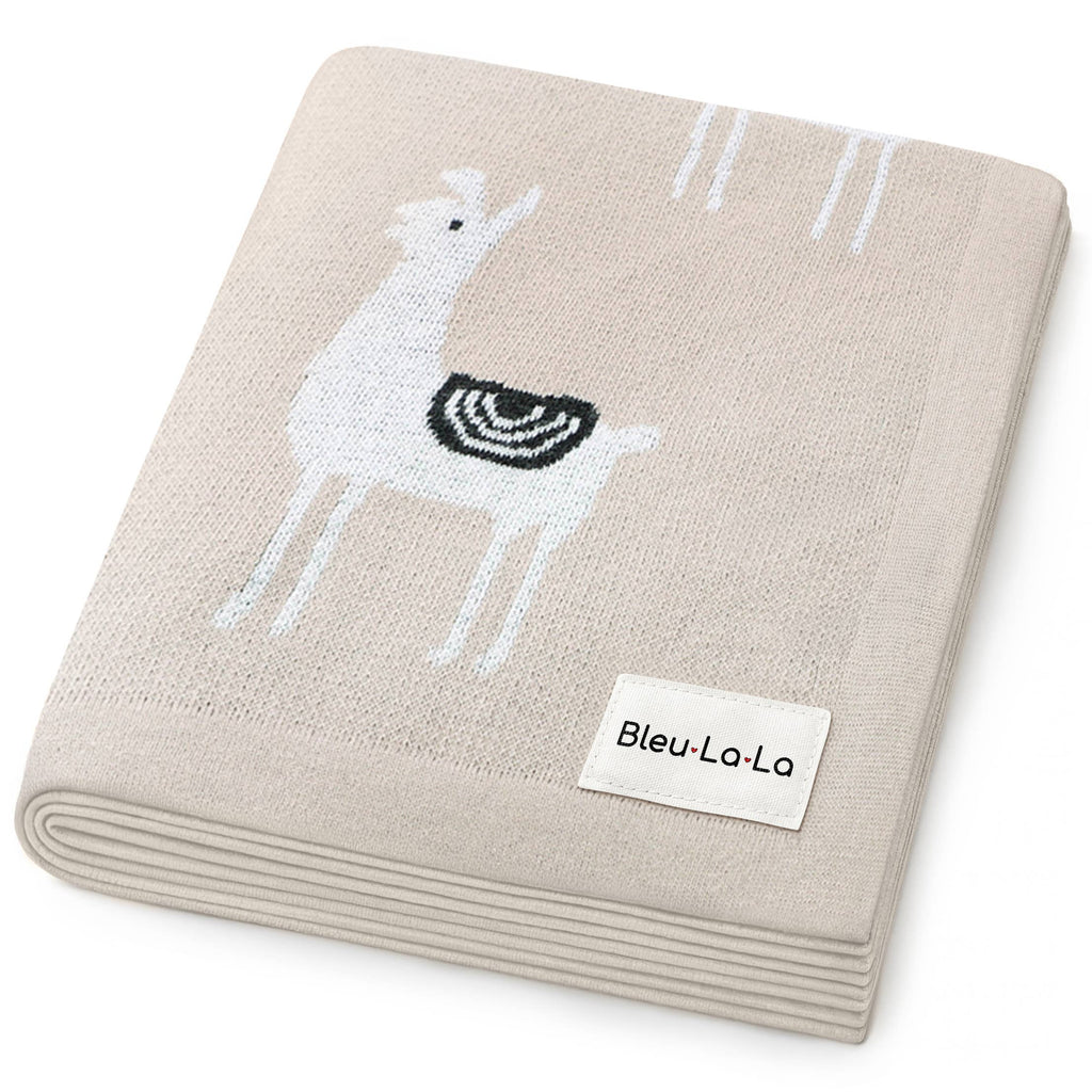 Beige blanket with embroidered deer design and Bleu-La-La label on a white background
