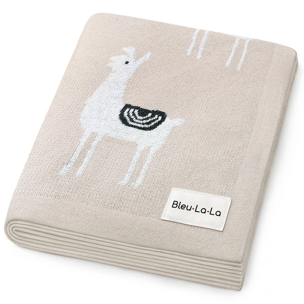 Beige blanket with embroidered deer design and Bleu-La-La label on a white background