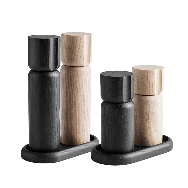 Set of black and wooden salt and pepper shakers on a white background