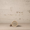 Small ceramic object with a textured surface on a beige background