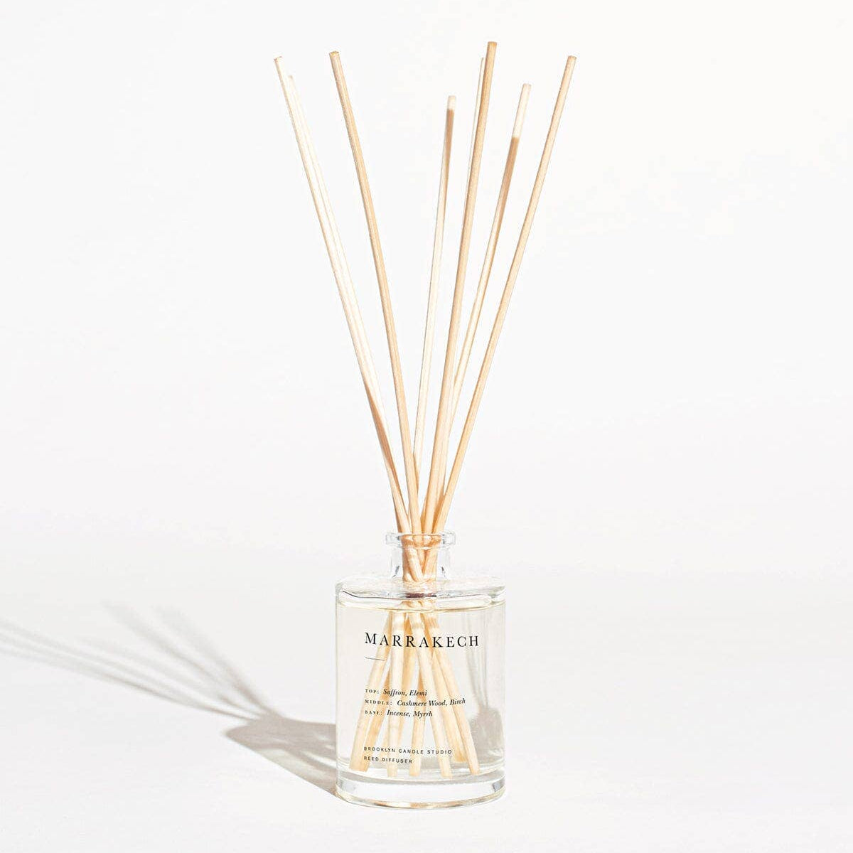 Diffuser with wooden sticks on a white background