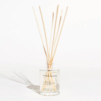 Diffuser with wooden sticks on a white background