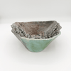 Ceramic bowl with textured surface on a white background