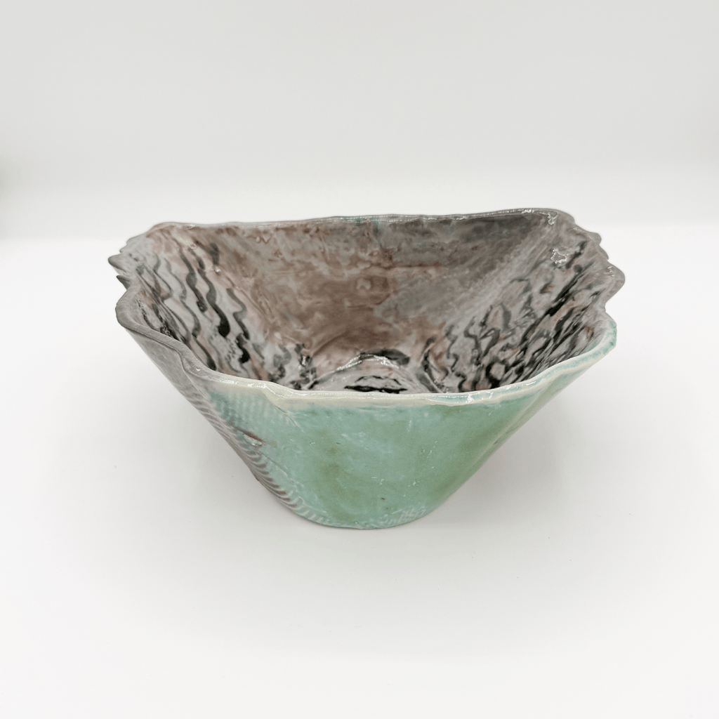 Ceramic bowl with textured surface on a white background