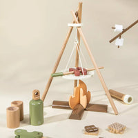 Wooden play set with a teepee structure, campfire, and accessories on a beige background