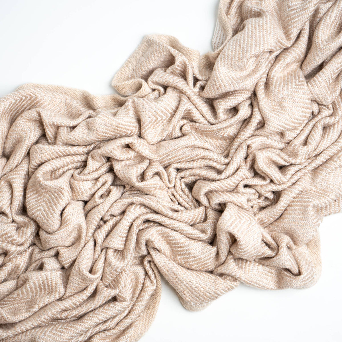 cream colored cashmere blanket on white background