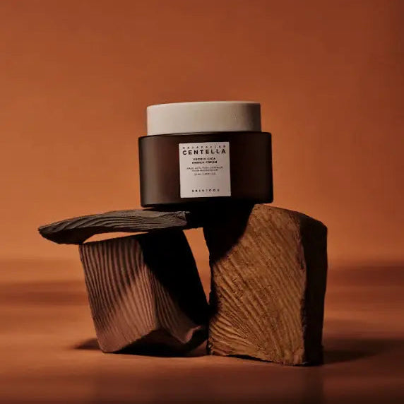 Cosmetic jar with a label on a textured brown surface