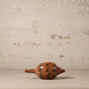 Decorative ceramic object with spiral patterns on a textured surface