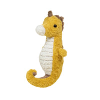 Plush toy seahorse on a beige background