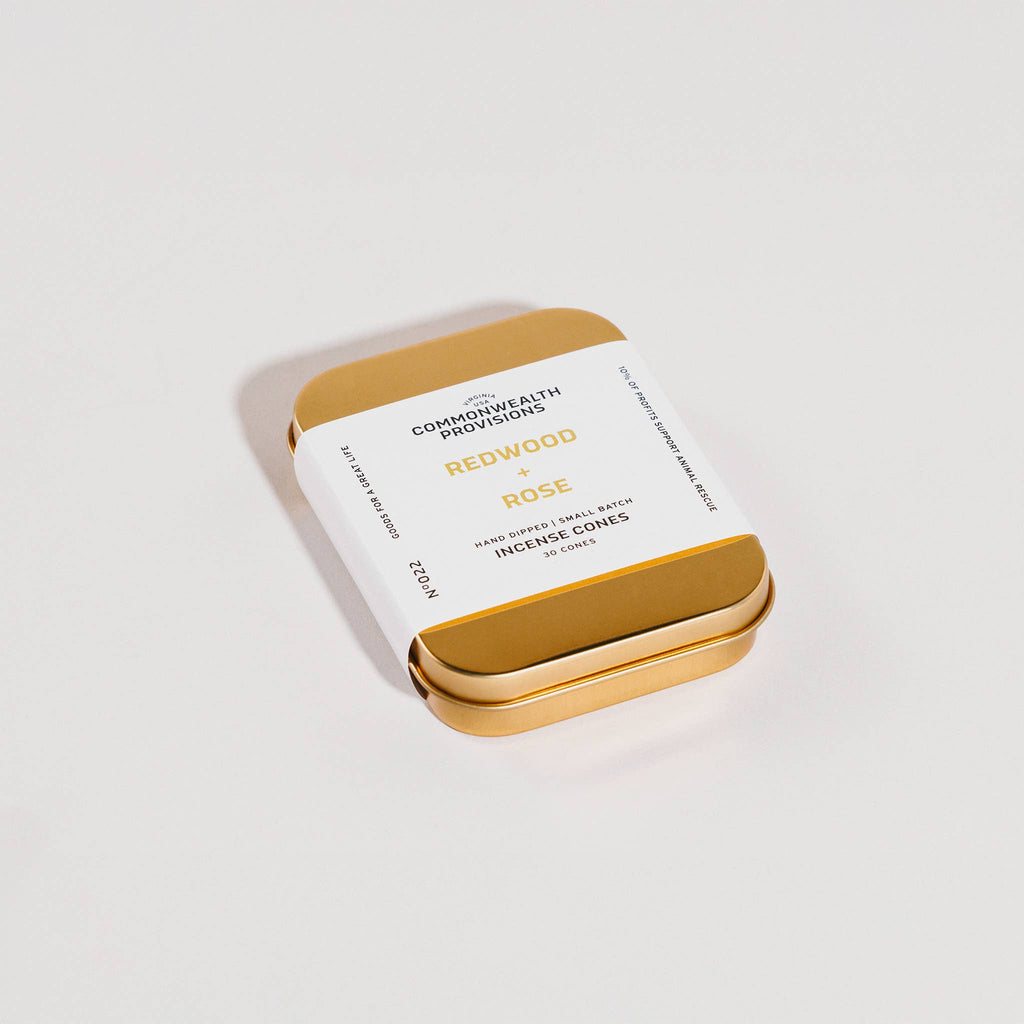 Gold tin of Incense Cones with label on a white background