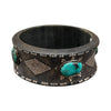 Dark brown leather cuff bracelet with turquoise stones and silver accents on a white background
