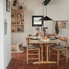 Dining area with wooden table, chairs, and decor in a home setting.