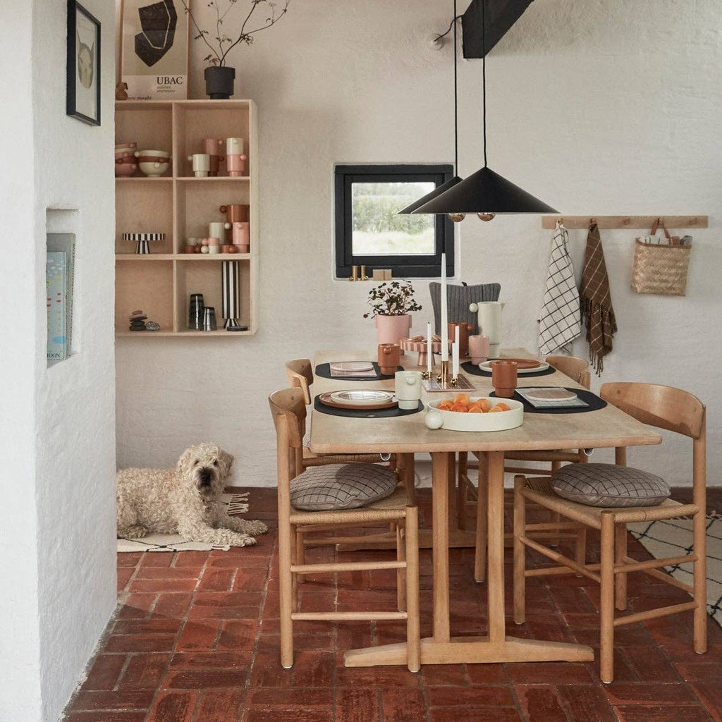Dining area with wooden table, chairs, and decor in a home setting.