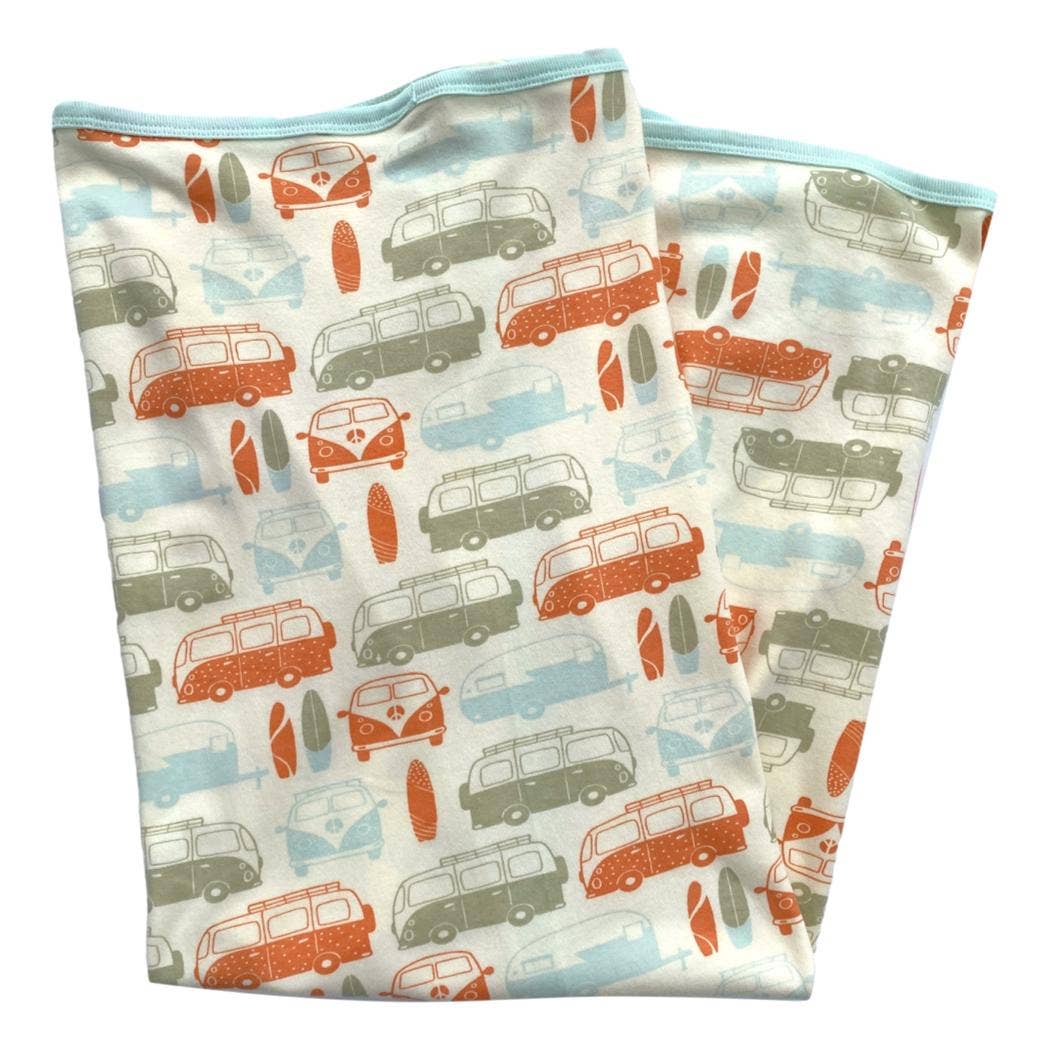 Two folded fabric swatches with vintage van pattern on a white background