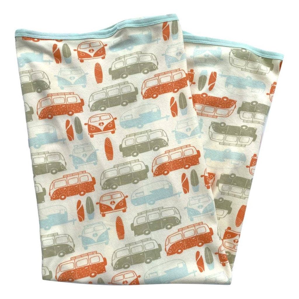 Two folded fabric swatches with vintage van pattern on a white background