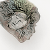 Ceramic bowl with textured surface on a white background