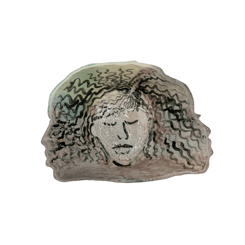 Decorative bowl with a face design on a white background