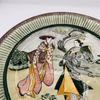 Ceramic plate with traditional Japanese scene of two women in kimono.