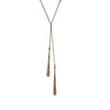 Long necklace with a pendant on a textured stone surface