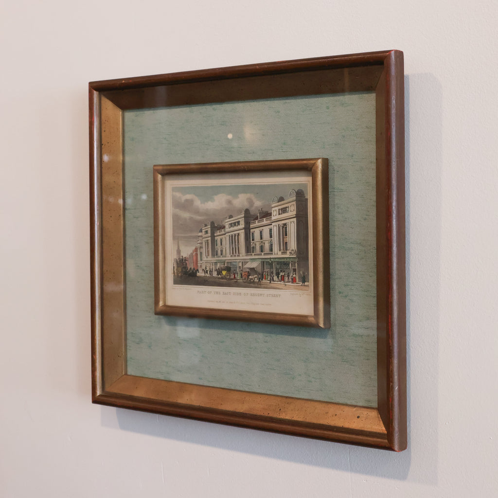 vintage print of east side of regent in brown wooden frame with light blue matting on a white wall