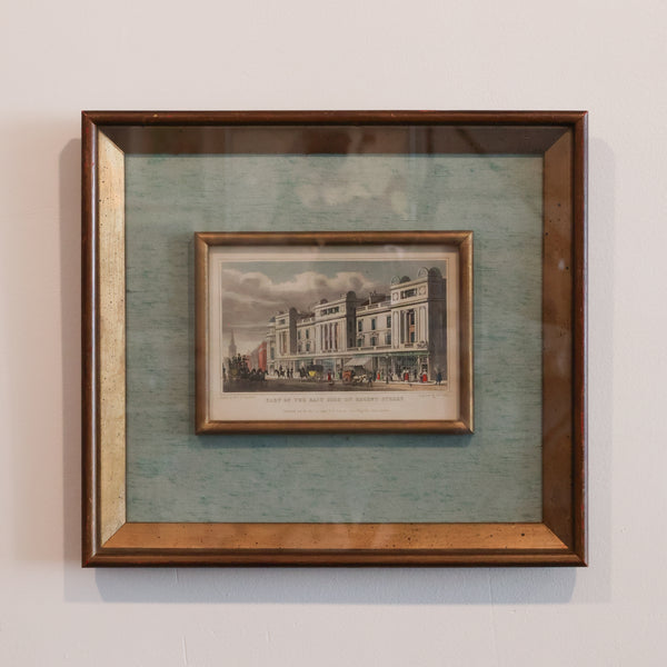 Framed print of a building on a textured green background